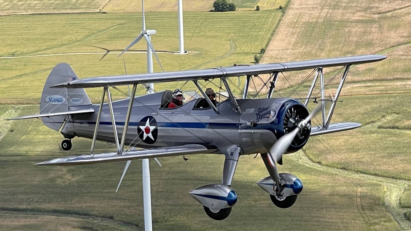 A close-up shot of the plane flying above grass