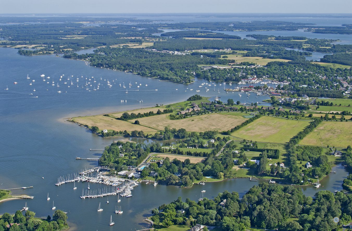 A view of the water from above shows many small boats in the water.